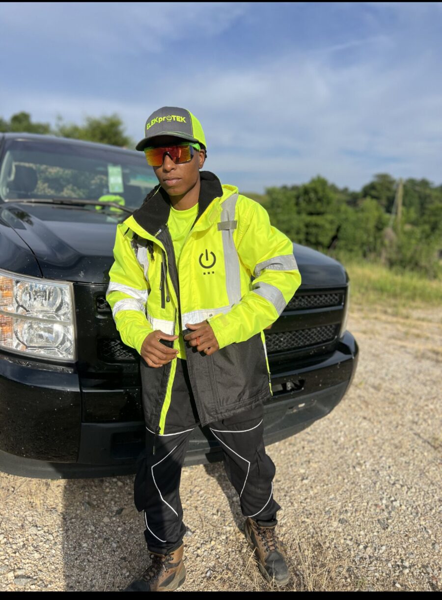 ELEKproTEK team member standing beside company service truck