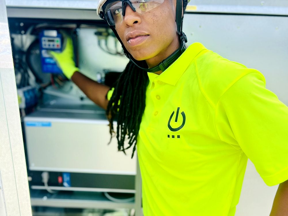 ELEKproTEK technician working on industrial HVAC control panel with VFD drive, Charleston SC